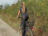 Watch Sandra riding her bike enjoying her shiny nylon Jumpsuit 7