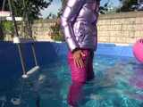 Watch Sandra enjoying her shiny nylon Downwear at a warm Summer Day in the Garden and in the Pool 6