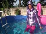 Watch Sandra enjoying her shiny nylon Downwear at a warm Summer Day in the Garden and in the Pool 7