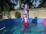 Watch Sandra enjoying her shiny nylon Downwear at a warm Summer Day in the Garden and in the Pool 9